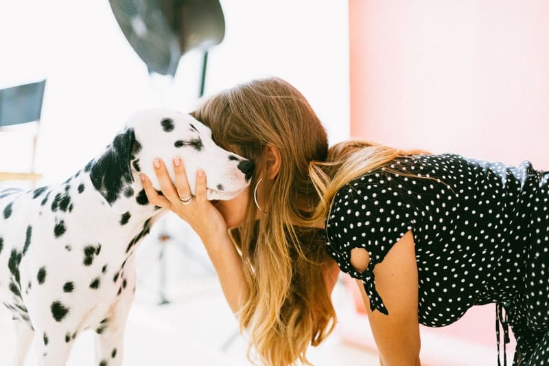 woman hugging her dalmation dog