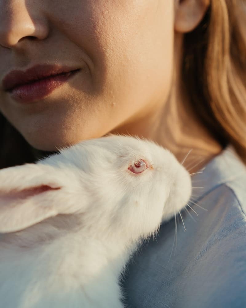 woman holding a white rabbit