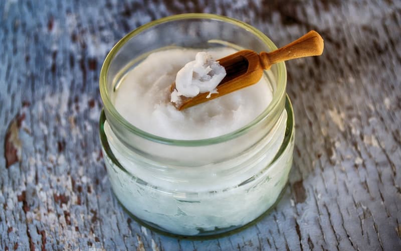 a jar of coconut oil with a scoop