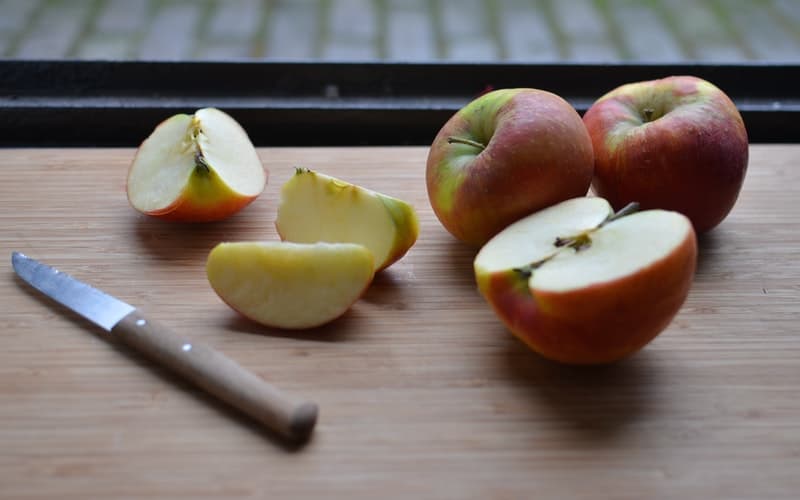 an apple on a cutting board