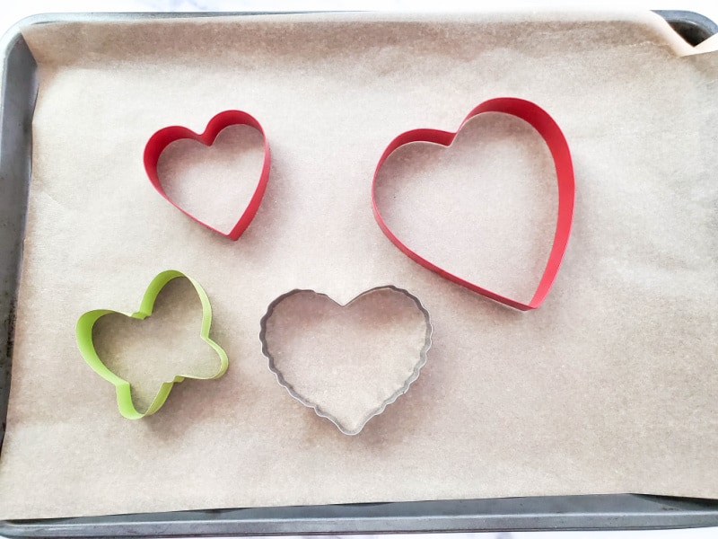 cookie cutters on a cookie sheet