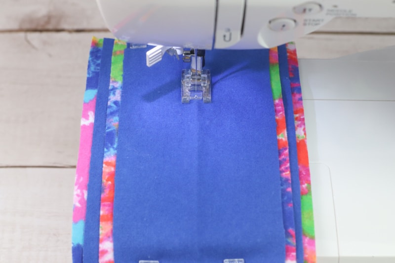 blue fabric on a sewing machine under the needle
