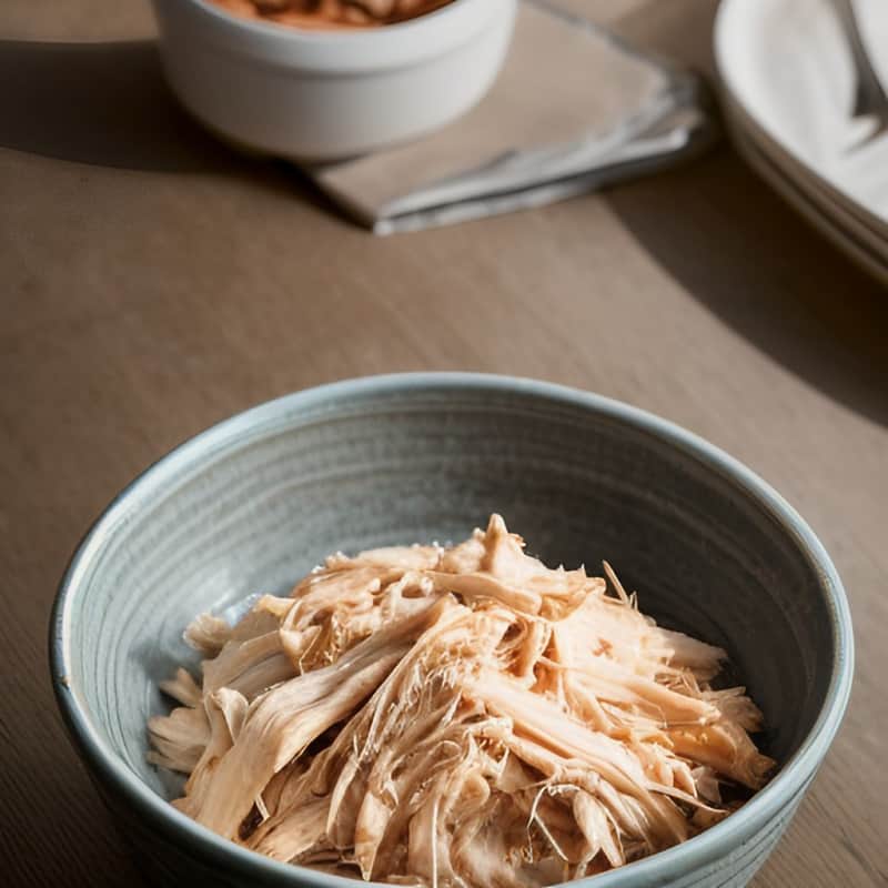 a bowl of cooked shredded chicken breast