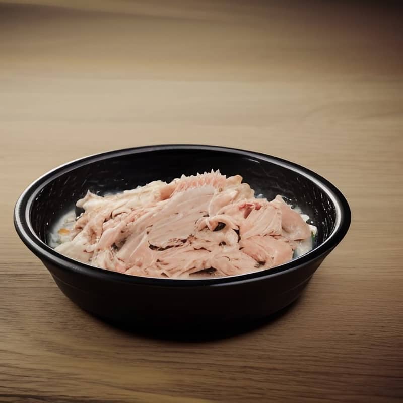 canned tuna in a black bowl