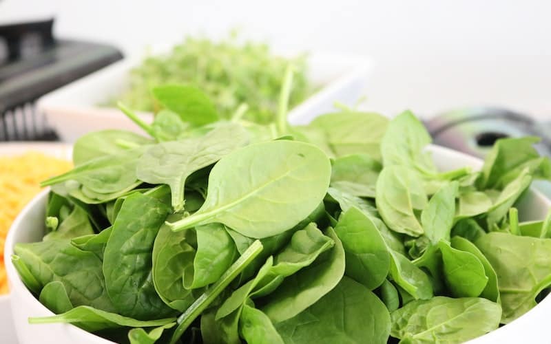 a bowl of baby spinach leaves