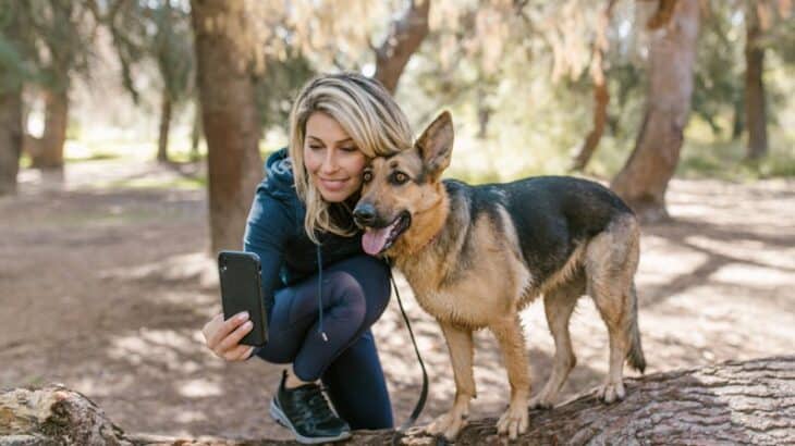 woman snapping a selfie with a dog